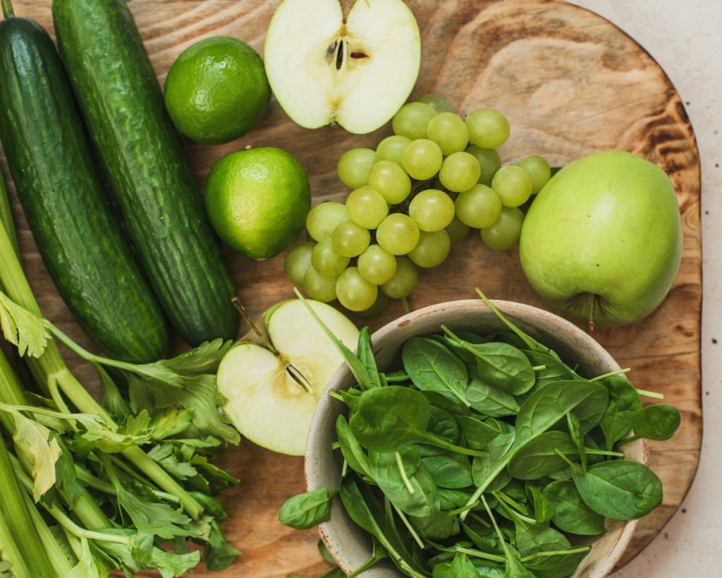Fresh ingredients for green juice including cucumber, apple, celery, spinach, grapes and lime prepared to enhance juice fast benefits