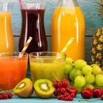 Fresh cold-press juices in a glass jars surrounded by ingredients — juice fast benefits for energy, gut reset, and clear skin