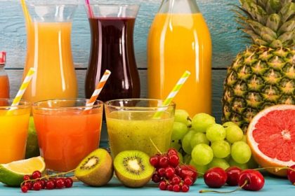 Fresh cold-press juices in a glass jars surrounded by ingredients — juice fast benefits for energy, gut reset, and clear skin