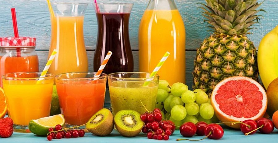 Fresh cold-press juices in a glass jars surrounded by ingredients — juice fast benefits for energy, gut reset, and clear skin