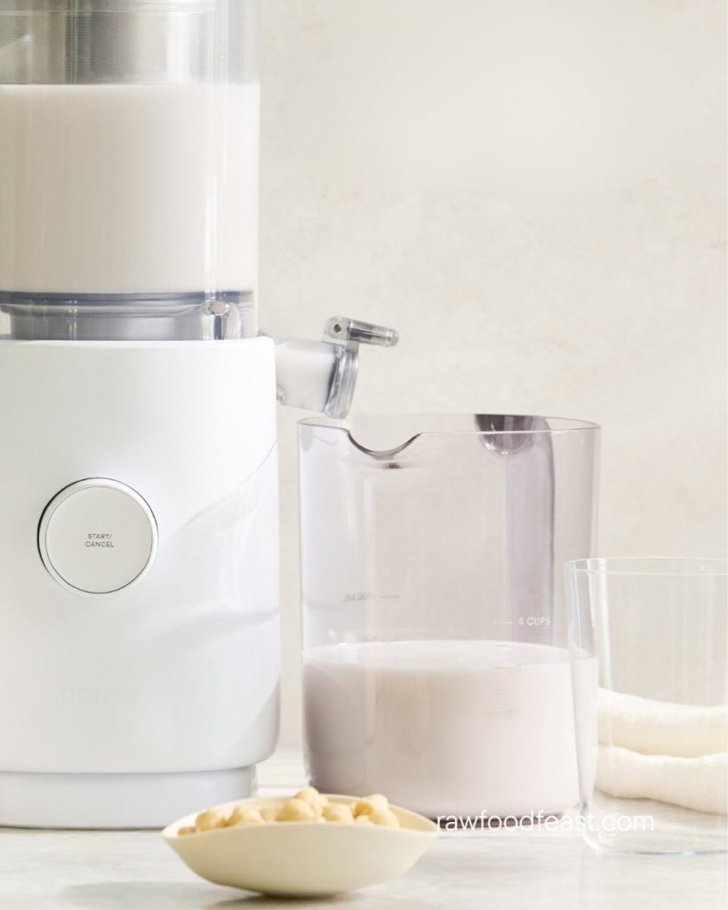 Nama M1 Plant-Based Milk Maker with cashews and fresh milk showing cold-press nut milk process at home