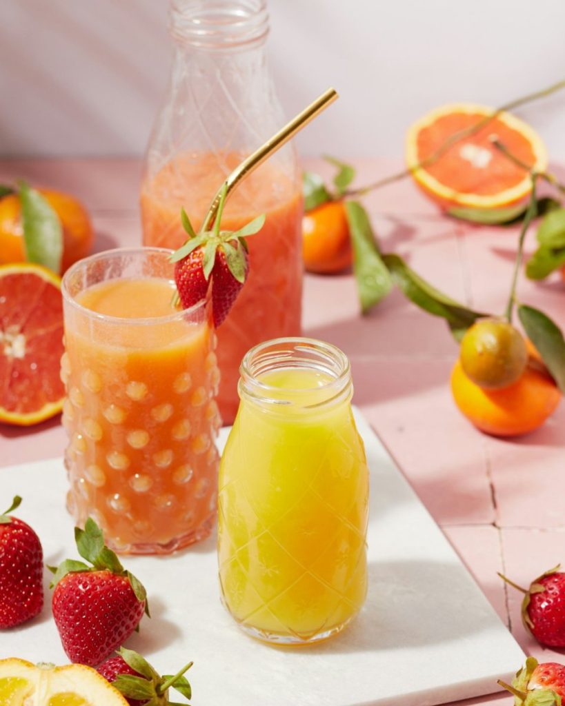 Fresh citrus juices with whole fruits and strawberries — the whole food answer to do I need supplements 