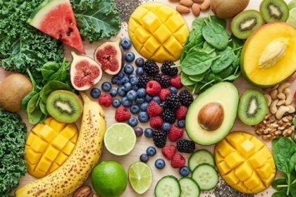 Does food combining work — abundant spread of fresh fruit, leafy greens, avocado, nuts and seeds on a light surface