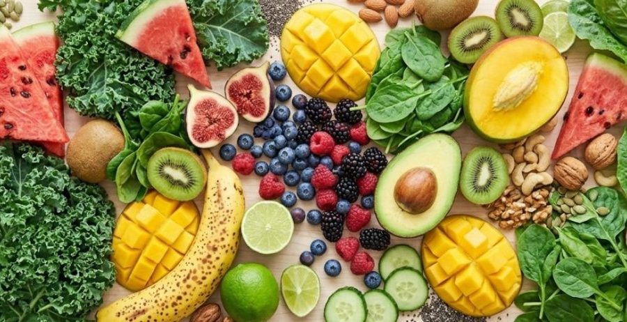Does food combining work — abundant spread of fresh fruit, leafy greens, avocado, nuts and seeds on a light surface