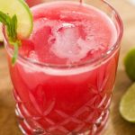 A refreshing glass of watermelon juice garnished with lime and mint, highlighting the hydration and watermelon juice benefits for skin.