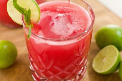 A refreshing glass of watermelon juice garnished with lime and mint, highlighting the hydration and watermelon juice benefits for skin.