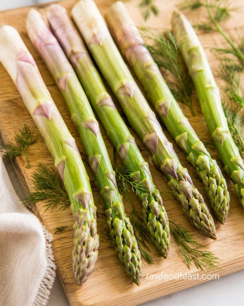 Close-up of raw asparagus spears with pale-purple bases and tender tips, the source of inulin prebiotic fiber