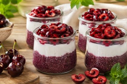 Cherry chia parfait with cherry chia pudding, vanilla coconut whipped cream, and fresh halved cherries