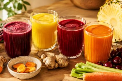 Juice for joint pain — four glasses of anti-inflammatory juice with turmeric, beet, pineapple, ginger, and tart cherries